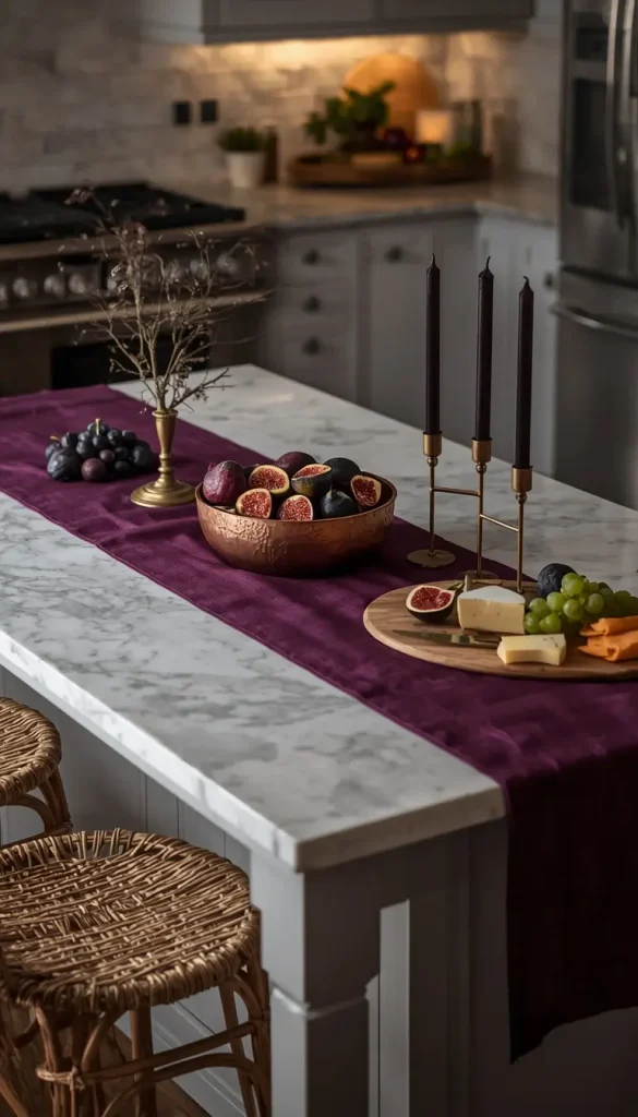 Kitchen island styled with a plum runner, copper bowl of figs and brass candles